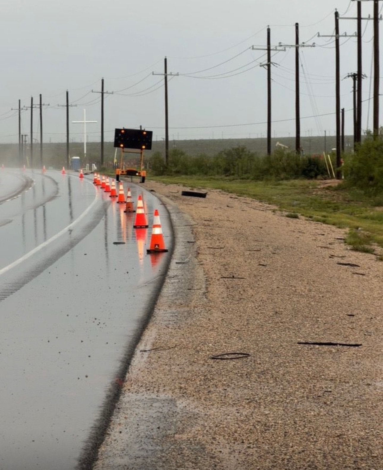 Highway shoulder closure with traffic cones and warning signs